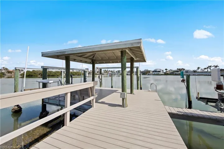 Deeded dock featuring your own boat slip and lift on the bay leading to the Gulf