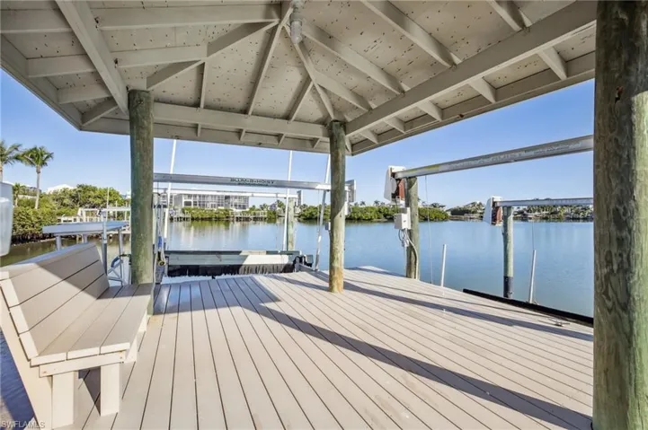 Deeded dock featuring your own boat slip and lift on the bay leading to the Gulf