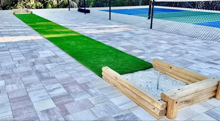 View of property's community with a tennis court