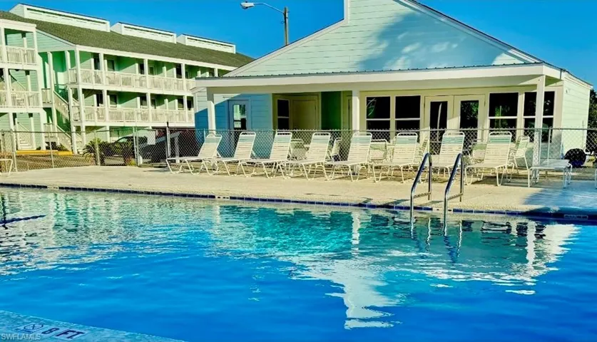 Community pool with a patio