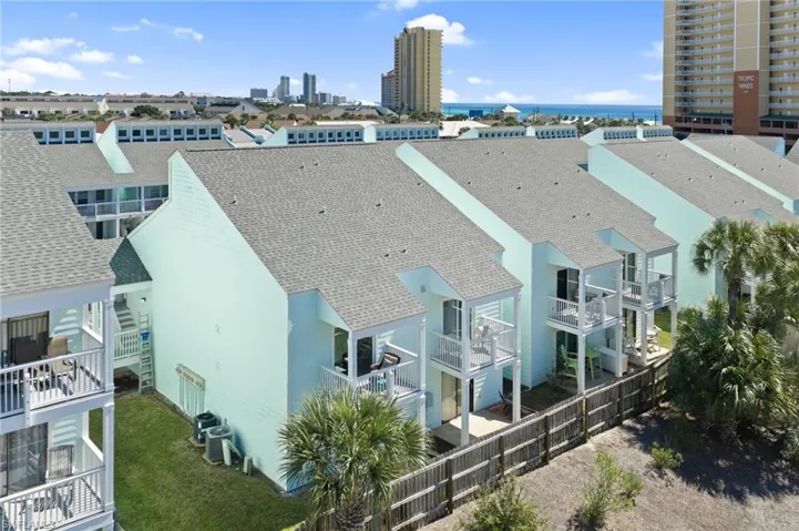 Drone / aerial view of a nearby body of water and apartment complex / building