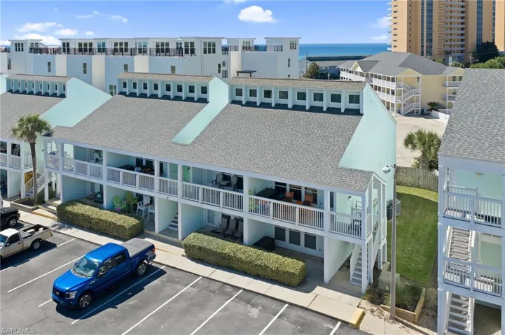 Drone / aerial view of apartment complex / building and a nearby body of water
