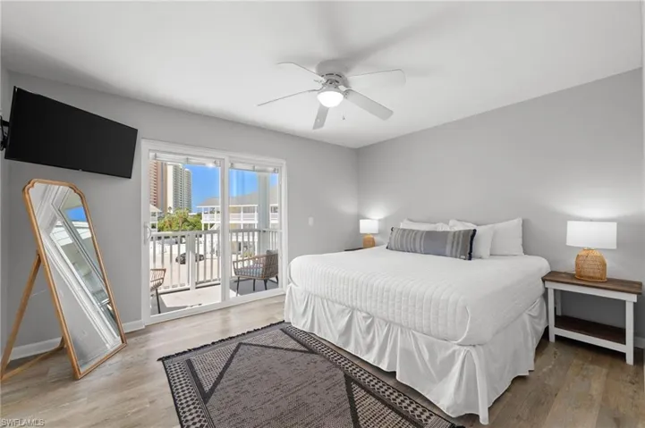 Bedroom featuring light wood finished floors, access to outside, and a ceiling fan