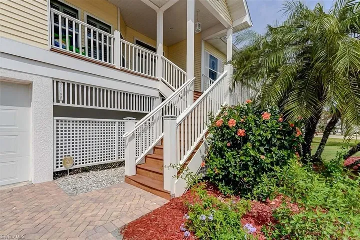 FRONT ENTRANCE.  PAVERED DRIVE.  LUSH LANDSCAPING.