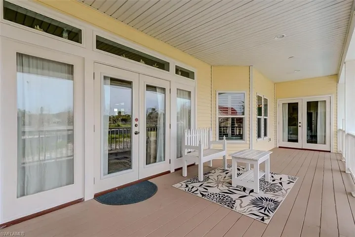 VIEW SHOWING ENTRANCE TO MAIN LIVING AREA FROM UPPER DECK.  ENTRANCE TO GUEST SUITE SHOWN AT REAR.