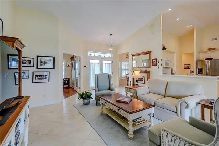 ANOTHER VIEW FROM THE LIVING AREA TOWARD HOME'S ENTRANCE.  DEN/FLEX ROOM ENTRANCE IS AT LEFT.  ENTRANCE TO FORMAL DINING ROOM IS TO RIGHT REAR.