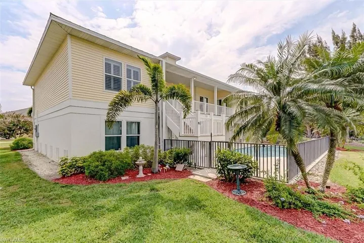 REAR OF HOME.  LUSH MATURE LANDSCAPING.  IRRIGATION SYSTEM.