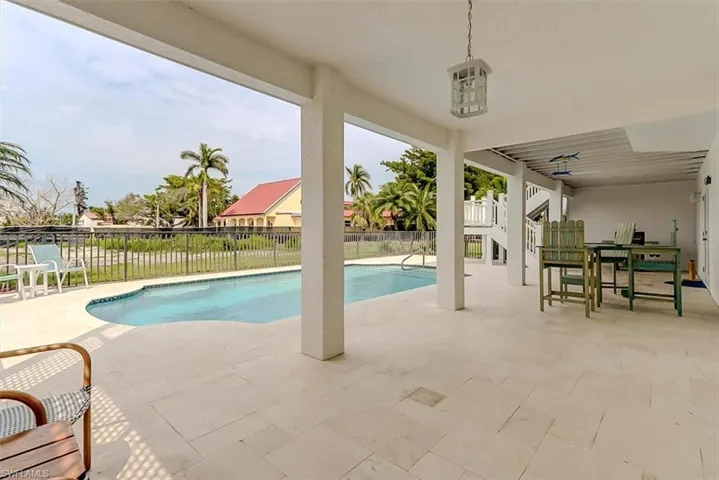 COVERED AREA IN POOL IS PERFECT FOR AL FRESCO DINING AND RELAXING OUT OF THE SUN
