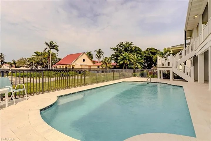 WESTERN EXPOSURE FENCED POOL WAS RESURFACED IN 2019.   SHELLSTONE PAVERS.  STAIRWAY LEADS TO UPPER LANAI.