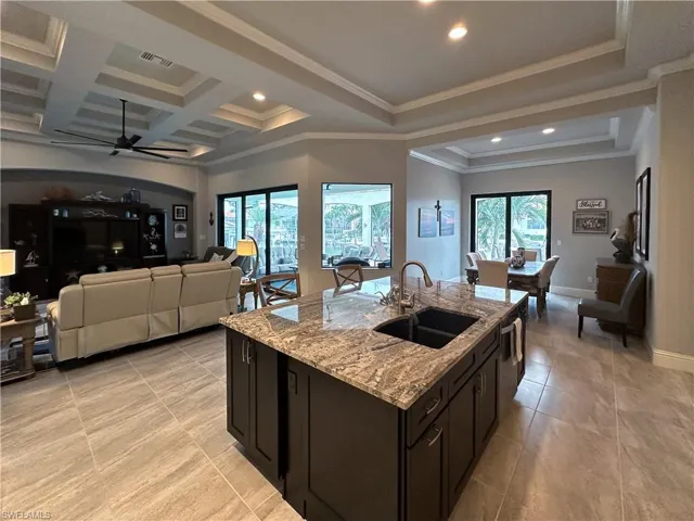 Open concept living with lots of natural light, looking on to the lanai and views of the canal. Notice the nice details in the ceilings.
