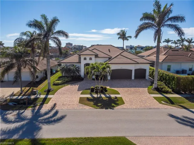 Arial view of front with circular driveway, 3 car garage