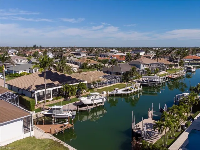 Aerial view of home with circular paver driveway.