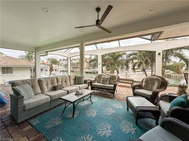 Lanai with ceiling fan and a water view, access to boat dock