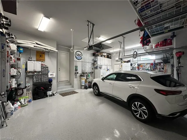 3 Car Garage with plenty of storage both overhead and shelving.