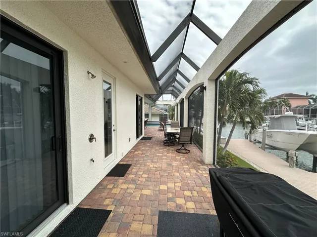 View of lanai with canal view and access to dock