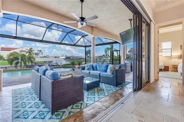 View of patio with ceiling fan, a lanai, and outdoor lounge area