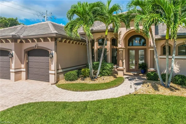 Mediterranean / spanish-style home featuring french doors and a garage