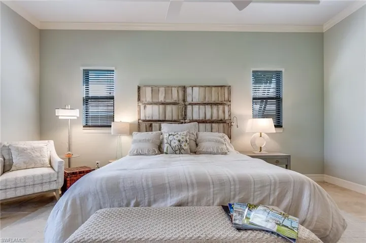 Bedroom featuring ornamental molding and ceiling fan
