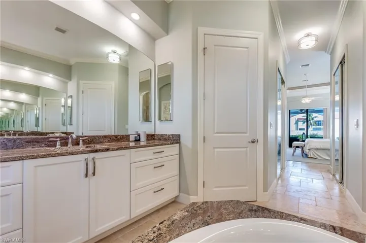 Bathroom with vanity and ornamental molding