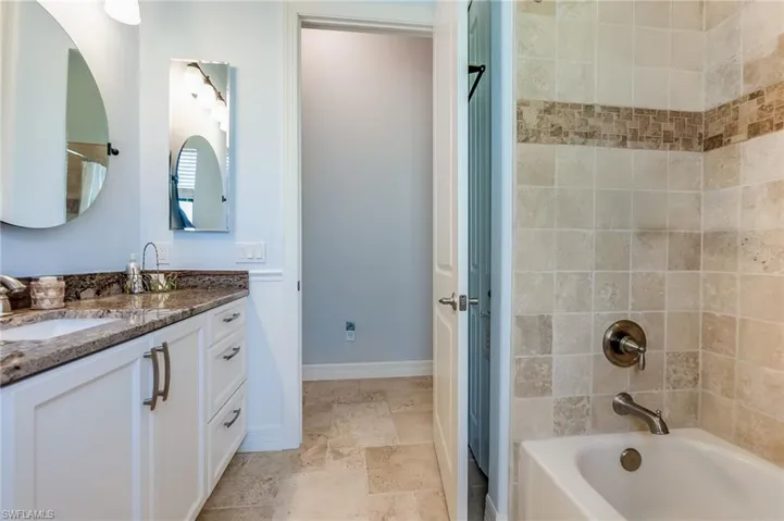 Bathroom featuring vanity and tiled shower / bath combo