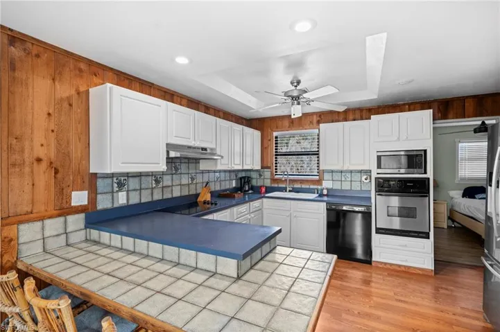 Kitchen with ample cabinet space and modern appliances  - Virtually Edited Image