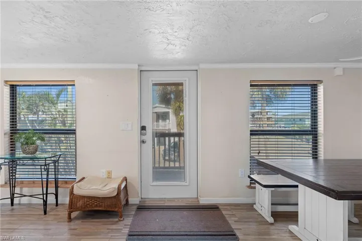Entryway offering a glimpse of the outdoors and easy access to the deck area - Virtually Edited Image