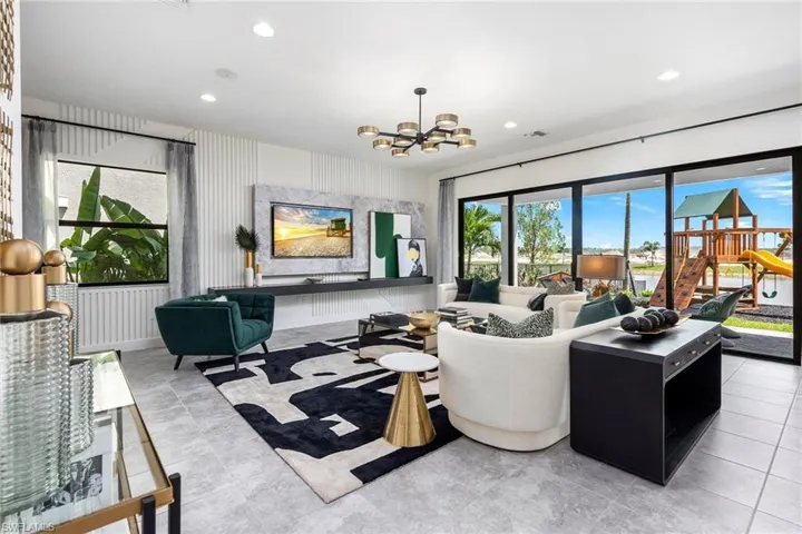 Living room featuring tile floors and a chandelier