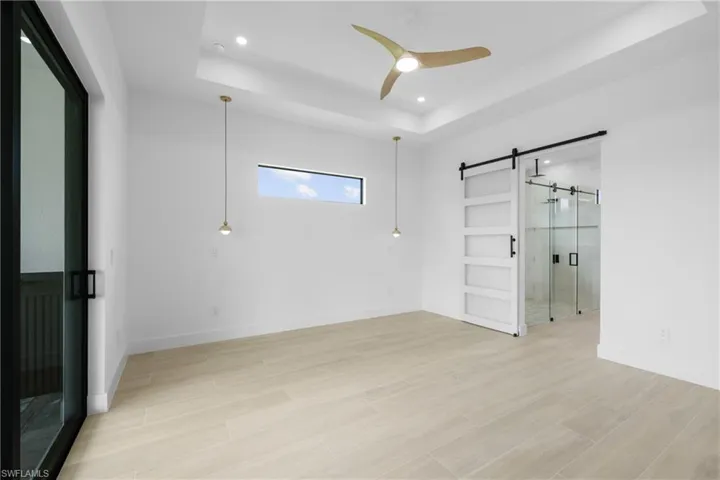 Full bathroom featuring a stall shower, double vanity, a soaking tub, recessed lighting, and tile walls