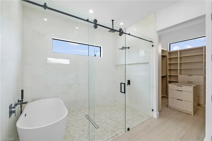 Bathroom view of double vanity and recessed lighting