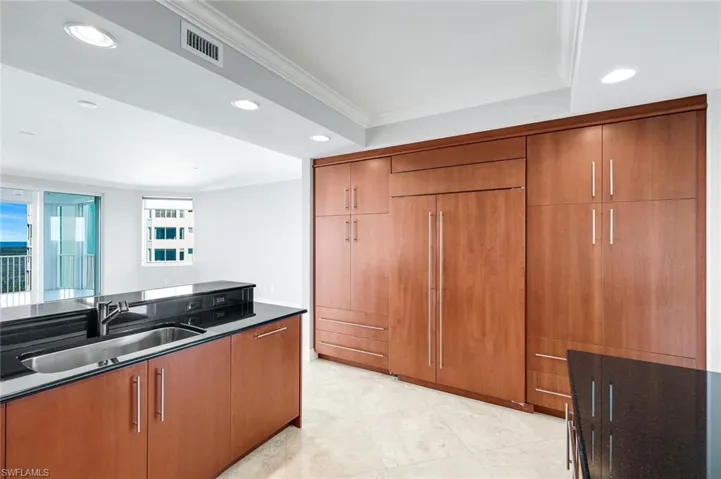Sleek Kitchen Cabinetry with Wood Paneled Subzero