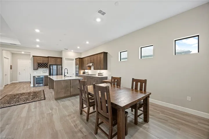 Dining area featuring recessed lighting, wood finish floors, and wine cooler