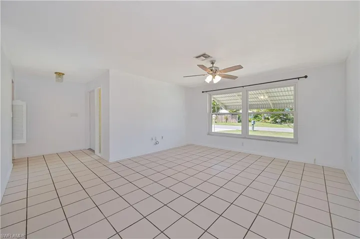 Unfurnished room with visible vents and ceiling fan