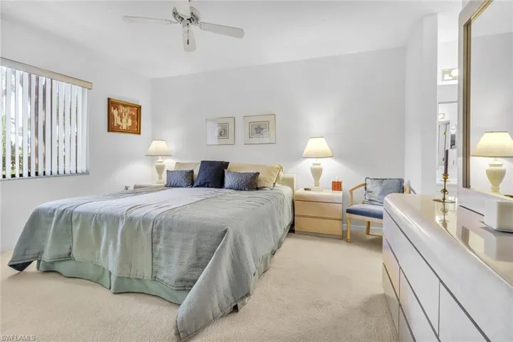 Carpeted bedroom featuring ceiling fan