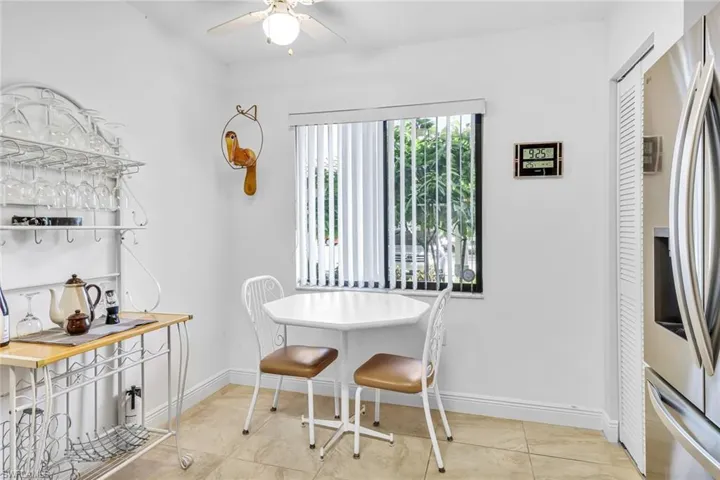 Dining space with light tile patterned floors and ceiling fan