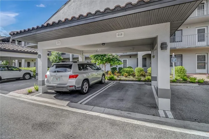 View of parking / parking lot with a carport