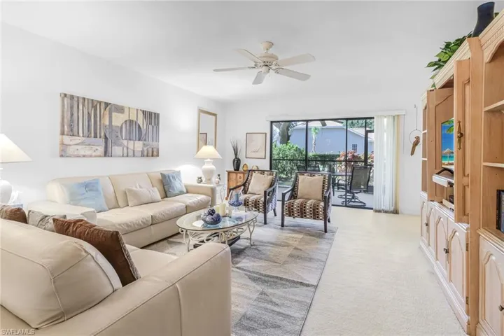 Living room featuring carpet floors and ceiling fan