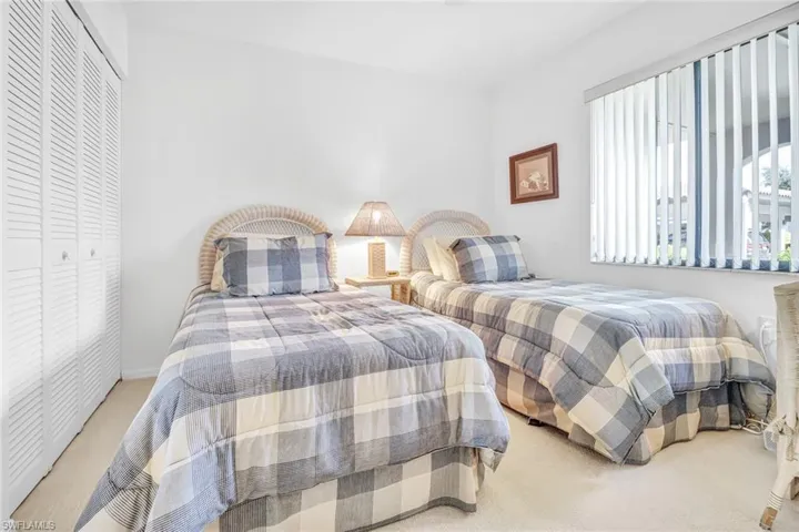 Carpeted bedroom with a closet