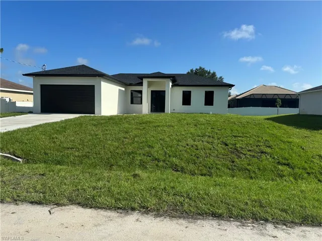 Prairie-style home featuring a garage and a front yard