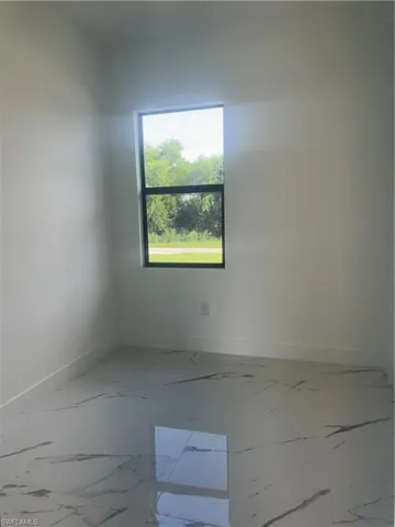 Spare room with tile patterned flooring