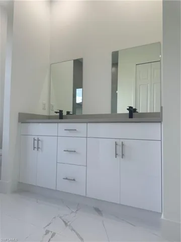 Bathroom featuring tile patterned flooring and vanity