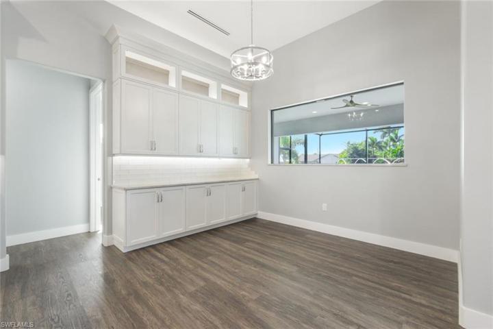 Open Dining with More Custom Cabinetry & Large Window Overlooking Lanai