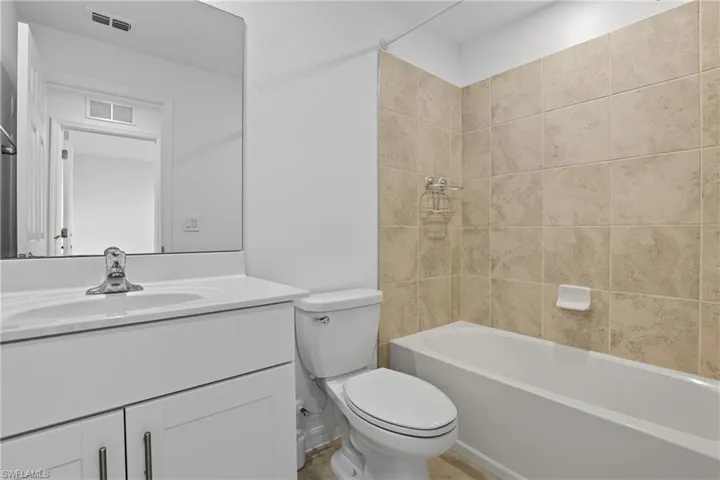 Full bathroom featuring shower / bath combination and vanity