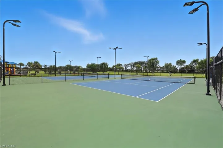 View of tennis court with community basketball court