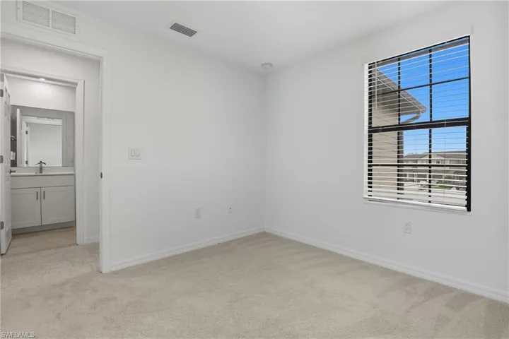 Unfurnished room with light carpet and baseboards