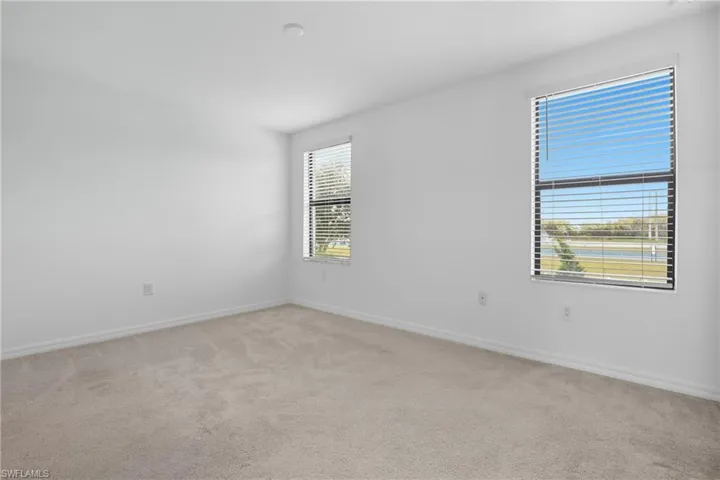 Unfurnished room featuring light carpet