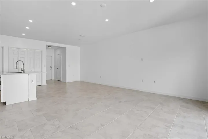 Unfurnished living room featuring recessed lighting