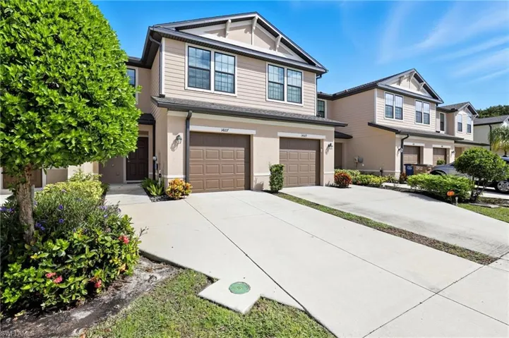 Craftsman house featuring driveway, a garage, and stucco siding