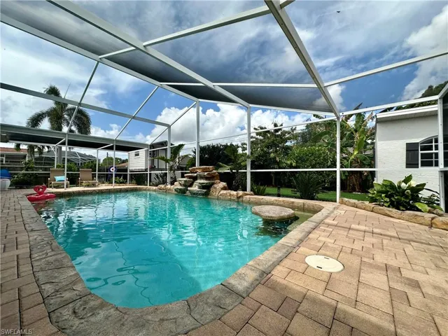 View of swimming pool with a patio and sneak peak of Cabana and Play hosue..