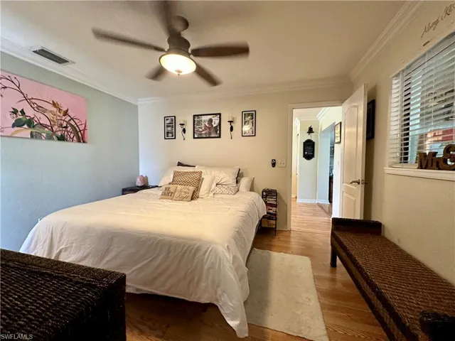 Main Bedroom featuring ceiling fan, hardwood / wood-style floors, and crown molding