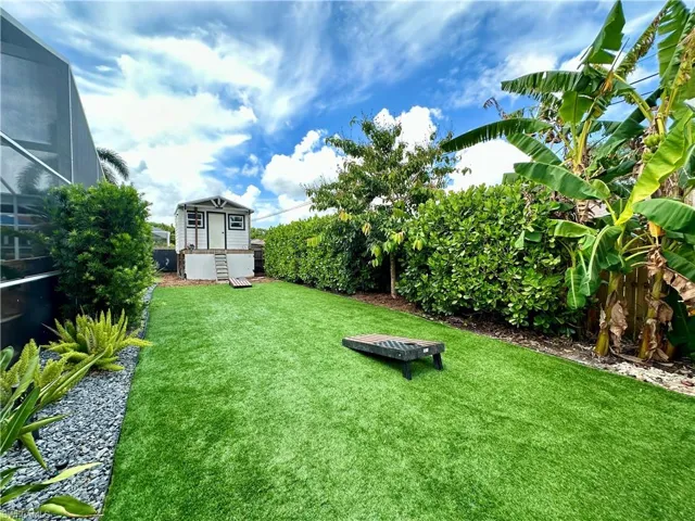 Green space behind pool to Play house with HVAC, NO MOW its Turf!